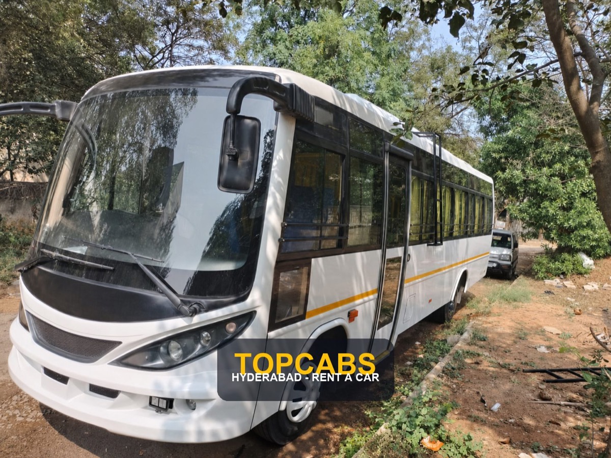 Watermarked TopCabs 28-seater AC coach exterior for Hyderabad group travel